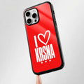 Phone case with 'I ❤️ Krsna' text on a red background, held by a finger.